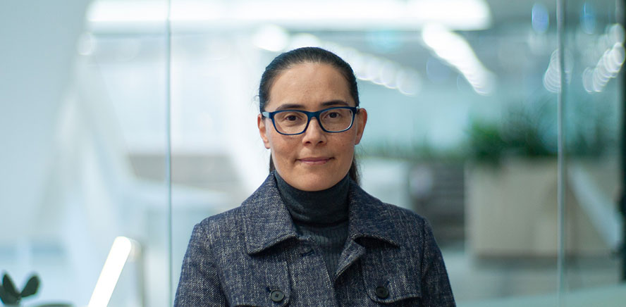 null Head shot of Cynthia Lui, Director, wearing a grey business jacket smiling at the camera.