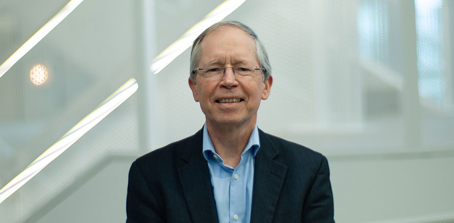 null Head shot of Jeremy Duffield, Director and Chair of Remuneration Committee, wearing a dark blue business jacket smiling at the camera.