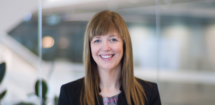 null Head shot of Rachel Reynolds, Head of Operations, wearing a black business suit and smiling at the camera.